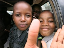 After a day at the park, they're all in the matatu on the way home. Ambrose is on the right.
